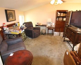 The TV room is filled with DVDs, audio books, CDs, wrapping paper, gift bags, tissue, ribbon and much more.  