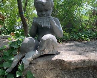 Sculpture of boy playing pan flute