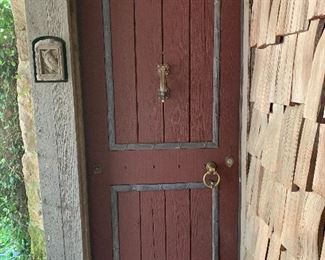 Cedar Entry Door features lead detailing and antique hardware 