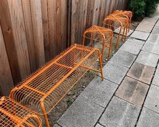 Multiple outdoor benches and stools