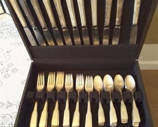 International Silver Plate Flatware. Knives, Forks, Salad Forks and Spoons with Storage Box. All items are Unpolished. 14 knives, 11 dinner forks, 16 salad forks, 21 teaspoons.