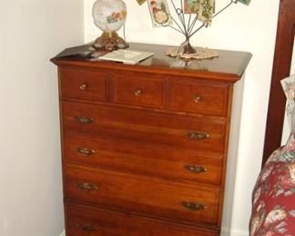 Vintage cherry chest of drawers, old postcards and gone with the wind lamp.