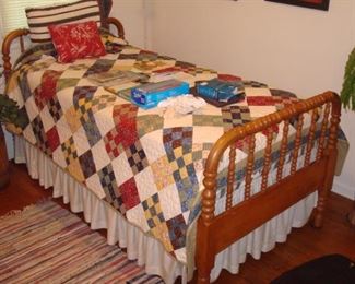 Antique Jenny Lind bed and quilt.