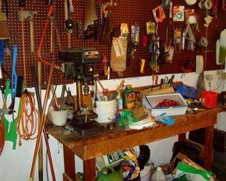 Work bench and tools including drill press.