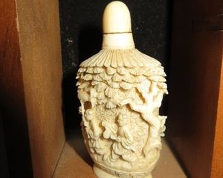 Intricately carved antique ivory snuff bottle.