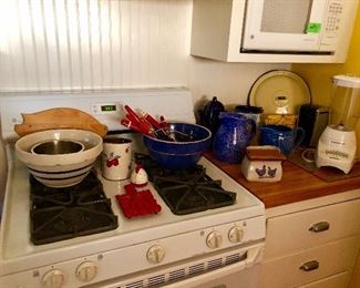 Kitchen items (mixing bowls, vintage red handle utensils, kithchen-aid blender, vintage pitchers, cutting boards)