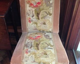One of two antique slipper chairs