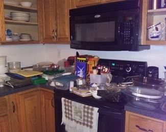 kitchen stocked with pots, pans, dishes, christmas dishes, pyrex, utensils, cutting boards, glassware, vintage china set