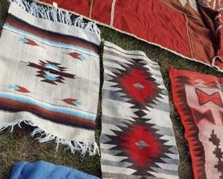At least 12 Indian and Mexican rugs and blankets