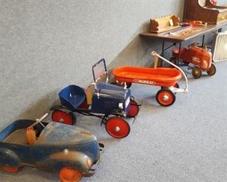 A few pedal cars, wagon and tractor