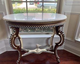 Oval table with marble top and black an white check accents