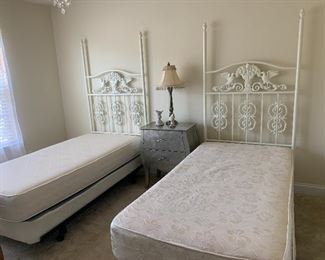 A pair of vintage white metal iron twin size beds