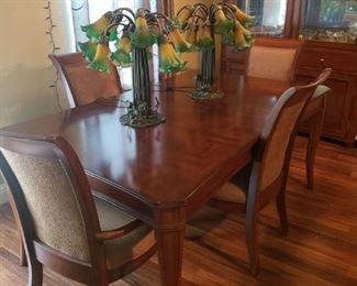 Dinning room Table with Six Chairs and a leaf.