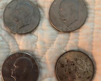 Peace Silver dollar and Eisenhower dollars as well as Morgan silver dollars and jewelry not shown here