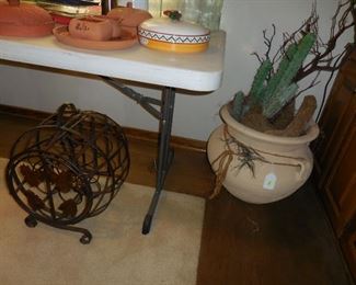 Wine rack; large pot with faux cactus
