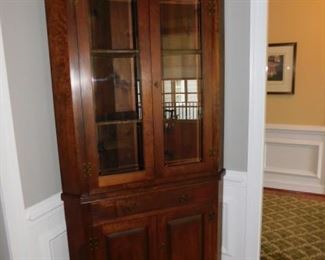 Gorgeous walnut and chestnut fronted antique heart pine corner hutch.  Three shelf display - double plate groove - center open single light glass doors.  Comes with a key - 42"W x 18.5"D x 82.5"H
