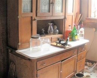 Large antique 4 Door Porcelain Top Hoosier Kitchen Cabinet.   Oops the booze is not for sale.