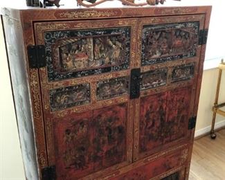 Early to mid-20th century Asian heavily carved, lacquered and decorated armoire