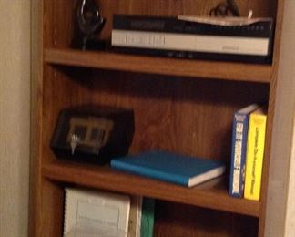One of the bookcases, Magnavox video cassette player, books (including vintage Webster's dictionary) , flip n file,