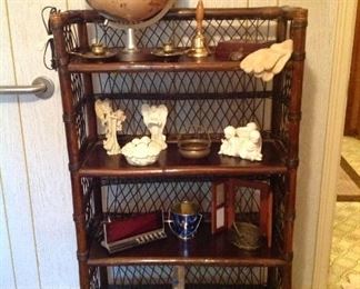 Rattan shelving unit, vintage globe, pair of brass candholders, angel collection brass baskets digital clock, picture frame, book, set of crouched hooks