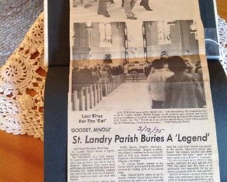 Newspaper clippings about the funeral for Sheriff Cat Doucet -1975 taped to the inside of the George Rodriquez book