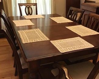 Dining table with eight upholstered seat chairs