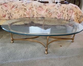 711:
Glass top and brass Frame coffee table
Glass is very thick and heavy coffee table measures approximately 52" long 26" wide 15" tall
