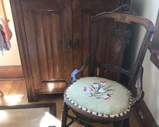 cabinet with linen fold doors and East lake chair