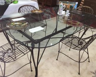 Custom-made heavy wrought iron table with ½" glass top (rectangular) and 4 arm chairs 