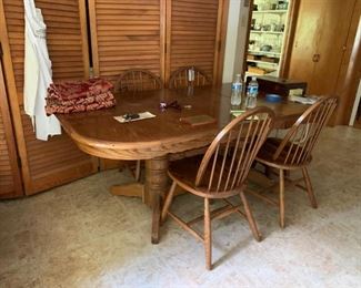 #12		double pedistal oak table as is top  w 1 leaf and 4 chairs 60-78x30	 $175.00 
