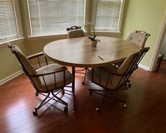 #24 laminate table with 4 rolling chairs w 1 leaf 42-59x42x29 $125.00