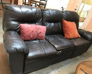 Leather Sofa - (damage and cracking on one of the cushions $ 60.00