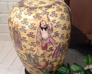 One of two pale yellow matching Asian urns
