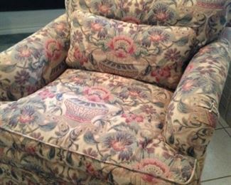 The chair has a coordinating ottoman and sofa.