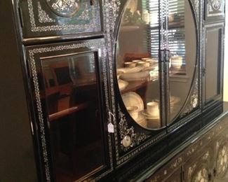 This incredible Asian style china cabinet provides unique display area and more than ample storage.