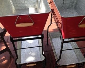 Two red (on wheels) beverage containers