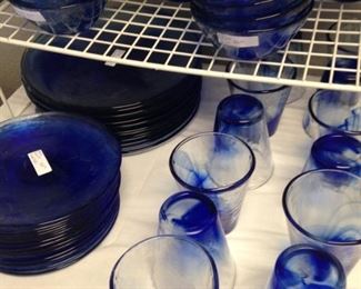 Blue plates, bowls, and glasses