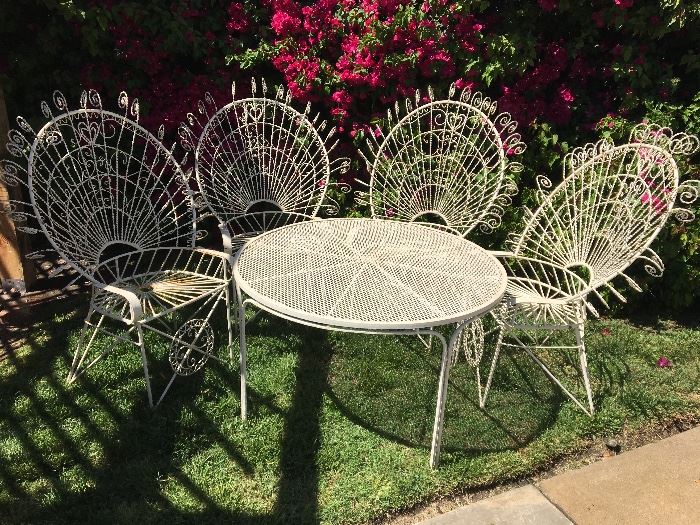 Wrought iron patio table. 3.5 foot diameter. 4 chairs.