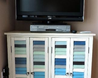 MULTICOLORED SHUTTER CABINET AND FLAT SCREEN TV