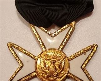 Gold trimmed white Maltese Cross medal