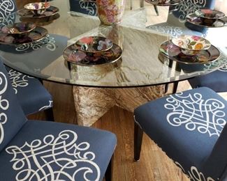 Two round glass top tables with stone bases