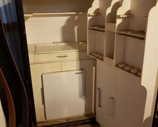 The inside of the safe with pull out drawer, storage for food and built in not working refrigerator