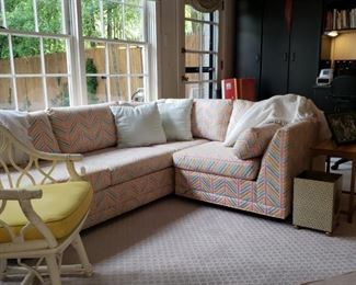Sectional sofa and a glimpse of a rattan painted armchair
