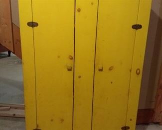 Painted yellow knotty pine cabinet
