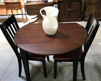 Drop leaf table with two chairs.
