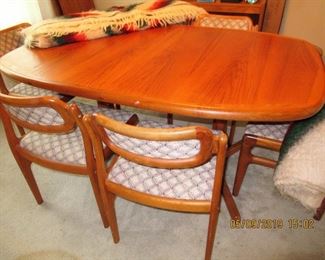 $800.00 DYRLUND TEAK TABLE HAS 6 MATCHING CHAIRS AND TWO TABLE EXTENSIONS, ASKING $800.00