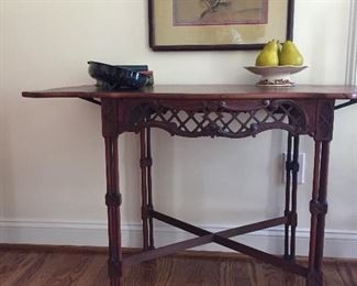 Beautiful side table with fretwork. Side leaves fold down. 