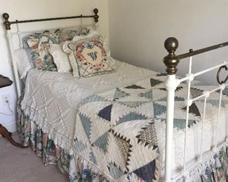 Antique metal twin bed. Linens and quilt available. 
