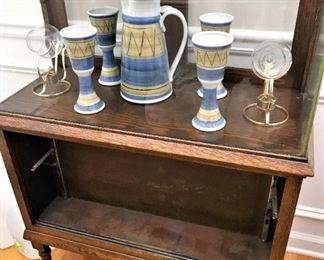 Signed Hage pottery sitting in vintage Amity leather display case