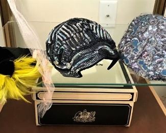 Close up of fascinator and other hats
